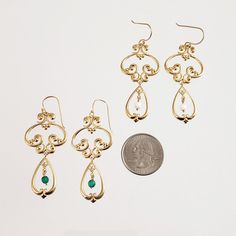 Step back in time with these elegant vintage style drop earrings. The intricate scrollwork design in 18K yellow gold plated bronze brings a touch of old-world glamour to your look, while the 4mm round faceted gemstone beads in your choice of green agate or white agate add a subtle pop of color. These earrings are the perfect finishing touch to any outfit, whether you're dressing up or down. Elevate your style with these beautiful and timeless earrings. Vintage Style Drop Earrings Scrollwork 4mm Elegant Green Chandelier Earrings With Intricate Design, Elegant Green Earrings With Intricate Design, Vintage Gold Earrings For May Birthstone, Classic Filigree Chandelier Earrings For Gift, Elegant Brass Jewelry With Intricate Design, Classic Filigree Chandelier Earrings As Gift, Elegant Green Brass Earrings, Elegant Antique Gold Nickel-free Earrings, Elegant Antique Gold-plated Earrings