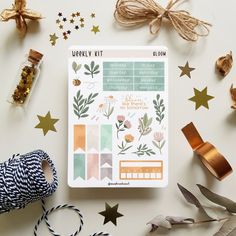 the contents of an autumn planner spread out on a table with gold stars and ribbons