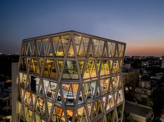 an unusual building is lit up at night