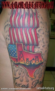 a man's leg with an american flag and oil rigs tattoo on it