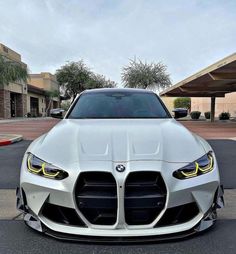 the front end of a white bmw car