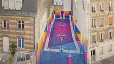 an aerial view of a skateboard ramp painted on the side of a tall building