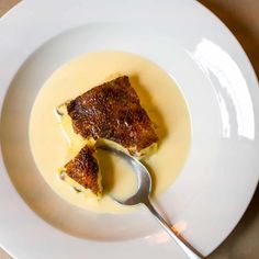 a white plate topped with food and a spoon