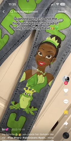 a pair of jeans with an image of princess and the frog on them