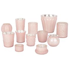 a collection of pink glass vases and candles