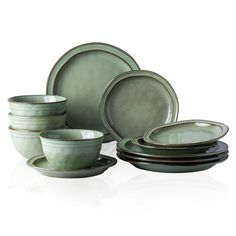 a set of green dishes and cups