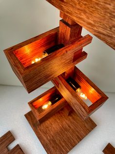 candles are lit in wooden boxes on the floor