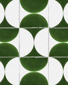 a green and white tiled wall with circles