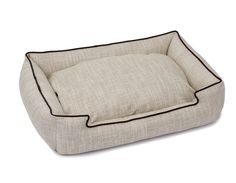 a dog bed that is made out of linen and has black piping on the sides