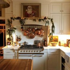 a kitchen filled with lots of pots and pans on top of a wall mounted oven