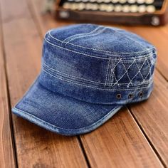 a denim hat sitting on top of a wooden table