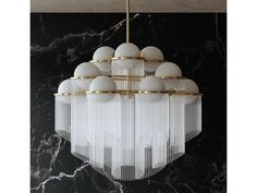 a chandelier hanging from the ceiling in a room with marble walls and flooring