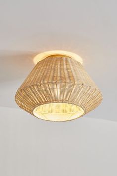 a light that is hanging from the ceiling in a room with white walls and flooring