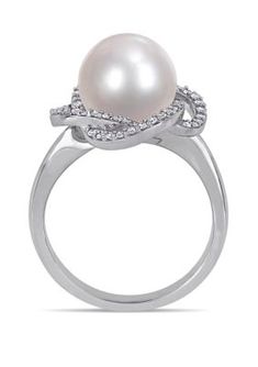 This modern and sophisticated Belk & Co. crossover halo ring is crafted in lustrous 14-karat White Gold and features an eye-catching solitaire cultured freshwater pearl at the center of its unique 56 round-cut, prong-set 1/4 ct. t.w. Diamond halo design. Instantly add a touch of elegance and class to any ensemble with this stunning pearl and diamond ring. | Belk & Co 1/4 ct. t.w. Diamond and 10 to 10.5 Millimeter Cultured Freshwater Pearl Swirl Ring in 14k White Gold, 7 Modern Twist Diamond White Rings For Formal Occasions, Modern Twist Diamond White Jewelry For Formal Occasions, Formal Diamond White Jewelry With A Modern Twist, Formal White Bypass Ring With Diamond Accents, Formal Diamond Pearl Ring With Halo, Formal Diamond Halo Pearl Ring, Modern Twist Diamond Jewelry For Formal Occasions, Elegant White Gold Bypass Ring With Diamond Accents, Elegant Diamond White Bypass Ring For Formal Occasions