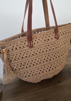 Crocheted bag with faux leather straps in a beautiful design Perfect for any occasion or as a gift! Crocheted from paper yarn🧶 Size approximately 46.5 x 27.5 cm with wide base Handmade crocheted with love🧡 Ready to ship📦 If you have any questions you can contact me at any time🌿 Feel free to follow me on instagram ➡️Mahzaatelier Paper Yarn, Yarn Sizes, Bag Crochet, Shopper Bag, Crochet Gifts, Beach Bag, Crochet Bag, Straw Bag, Beautiful Design