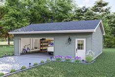 a garage with a bicycle parked in front of it and flowers on the lawn next to it