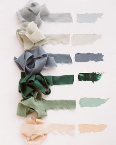 several different colors of paper on a white surface with one torn off and the other unrolled