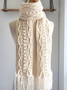 a white knitted scarf hanging on a wall