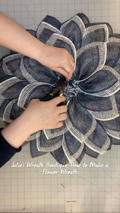 two hands are working on a flower made out of mesh and fabric with the words, little's wash boutiquehouse how to make a flower wreath