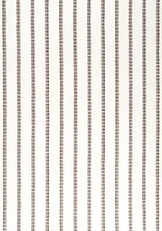 a white and brown striped wallpaper with vertical lines on the bottom half of it