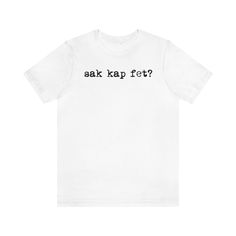 This classic Sak Kap Fet? unisex jersey short sleeve tee fits like a well-loved favorite. Soft cotton and quality print make users fall in love with it over and over again. These t-shirts have-ribbed knit collars to bolster shaping. The shoulders have taping for better fit over time. Dual side seams hold the garment's shape for longer. \n.: 100% Airlume combed and ringspun cotton (fiber content may vary for different colors)\n.: Light fabric (4.2 oz/yd² (142 g/mn.: Retail fit\n.: Tear away label Basic Short Sleeve Shirt With Funny Text, Haitian Flag, Haiti, Jersey Shorts, Cotton Fiber, Light Fabric, Ribbed Knit, Short Sleeve Tee, Adult Outfits