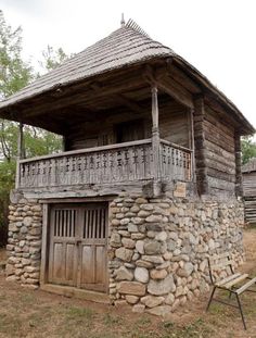 an old wooden building with stone walls and balcony