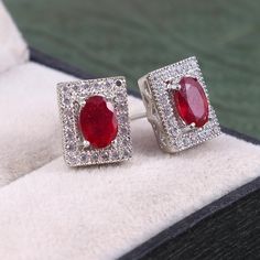 This Sterling Silver Earring features an Elegant Art With Natural Red Ruby Gemstone surrounded by tiny Zircons. The cavity is made from genuine solid 925/92.5 Sterling silver and stamped as S925. This Jewelry is Lead free and finished with Rhodium to resist scratches and tarnish. ITEM DESCRIPTION Item Code: JAER169 Metal: 925/92.5 Sterling Silver Gemstone: Genuine Natural Red Ruby(Fissure filled) Gemstone Shape: Oval Gemstone Size: 5 x 7 MM Earring Length: 11 MM Earring width: 9 MM Weight: 3.56 Sterling Silver Gemstone Cluster Earrings As Gift, Red Cubic Zirconia Earrings For Gift, Red Cubic Zirconia Fine Jewelry Earrings, Fine Jewelry Red Cubic Zirconia Earrings, Ruby Earrings With Halo Design For Anniversary, Classic Red Cubic Zirconia Earrings, White Gold Ruby Earrings With Halo Design, Ruby Halo Earrings For Anniversary, Classic Red Halo Design Earrings