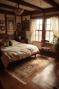 a bedroom with a bed, chair and rug in the corner next to two windows