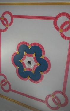 the ceiling is decorated with blue, pink and gold circles on white paper in an elegant manner