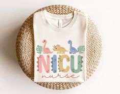 a white t - shirt with the words pepps and dinosaurs on it sitting next to a wicker basket