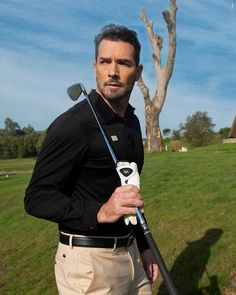 a man holding a golf club in his hands