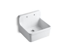 a white sink sitting on top of a wall