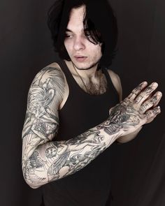 a man with tattoos on his arm and arms