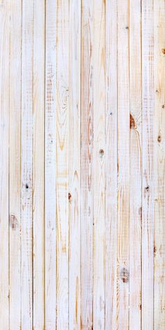 an old wooden wall with white paint and wood planks in the center, as background or texture