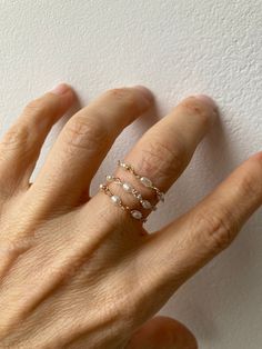 This little chain ring offers a fresh take on a traditional band ring. It is also very lightweight and comfortable to wear.  D E T A I L S *Made with AAA grade cultured freshwater rice pearls. These are very small measuring between 2- 4mm x 1.5mm. *Choose between a 14k gold filled, rose gold filled or sterling silver chain. *Gold fill is a wonderful alternative to gold and unlike gold plating does not rub off. *Choose the size you prefer from the drop down menu.  *Ring comes with a matching crystal information card and is ready for gifting. S I Z I N G * H E L P:  The the most accurate way to determine your ring size is to be professionally measured by a jeweller.  There are also several at-home sizing tools and tips to help find your ring size. The MOST COMMON RING SIZES for women are siz Delicate 14k Gold Filled Midi Rings In Rose Gold, Delicate 14k Rose Gold Filled Midi Rings, Delicate Pearl Charm Ring Jewelry, Delicate Pearl Charm Ring, Delicate Pearl Open Ring Jewelry, Dainty Rose Gold Pearl Ring For Promise, Dainty Rose Gold Pearl Promise Ring, Adjustable Dainty Rose Gold Pearl Ring, Adjustable Rose Gold Dainty Pearl Ring