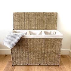 a wicker bench with two storage bins on top