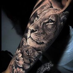 a man with a lion and flower tattoo on his arm