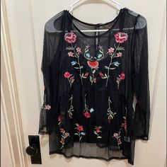 Flowy Fine Mesh With Flower Embroidery Black Embroidered Hem Blouse For Spring, Black Blouse With Embroidered Hem For Spring, Fall Black Top With Floral Embroidery, Black Embroidered Hem Top For Summer, Black Embroidered Long Sleeve Top For Spring, Black Long Sleeve Embroidered Top For Summer, Black Embroidered Long Sleeve Top For Summer, Casual Black Blouse With Floral Embroidery, Black Embroidered Summer Blouse