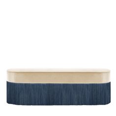 a blue and beige bench on a white background with the top half covered in fringes