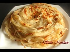 a white plate topped with sliced onions on top of a table