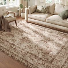 a living room filled with furniture and a large rug