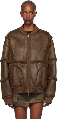 Faux-suede bomber jacket. Fleece trim and studs throughout. · Paneled construction · Rib-knit stand collar, hem, and cuffs · Two-way zip closure · Press-stud flap pockets · Dropped shoulders · Leather logo patch at back · Fleece lining · Welt pockets at interior · Logo-engraved antiqued bronze-tone hardware Supplier color: Brown Luxury Fall Outerwear With Rivets, Feng Chen Wang, Interior Logo, Leather Logo, Welt Pockets, Flap Pocket, Stand Collar, Outerwear Jackets, Faux Suede