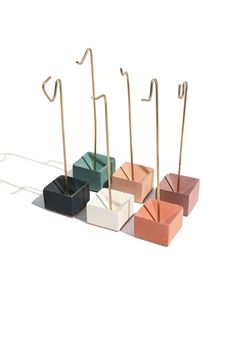 four different colored boxes with wooden sticks sticking out of them