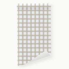 a piece of paper with a white checkered pattern on it and a corner cut in half