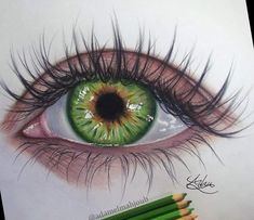 a drawing of an eye with green eyeshade and pencils next to it