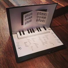 an open box with musical notes and piano keys