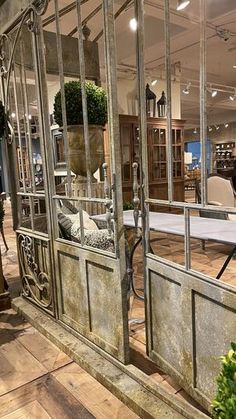 the inside of a furniture store with glass doors