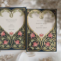 the wedding card is decorated with gold and pink flowers, which are accented by an intricately designed heart