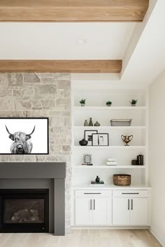 a living room filled with furniture and a fire place in front of a stone wall