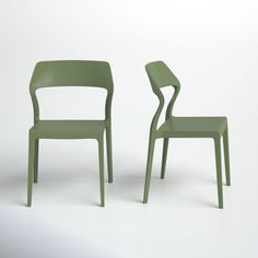 two green chairs sitting next to each other on a white surface with one chair facing the other